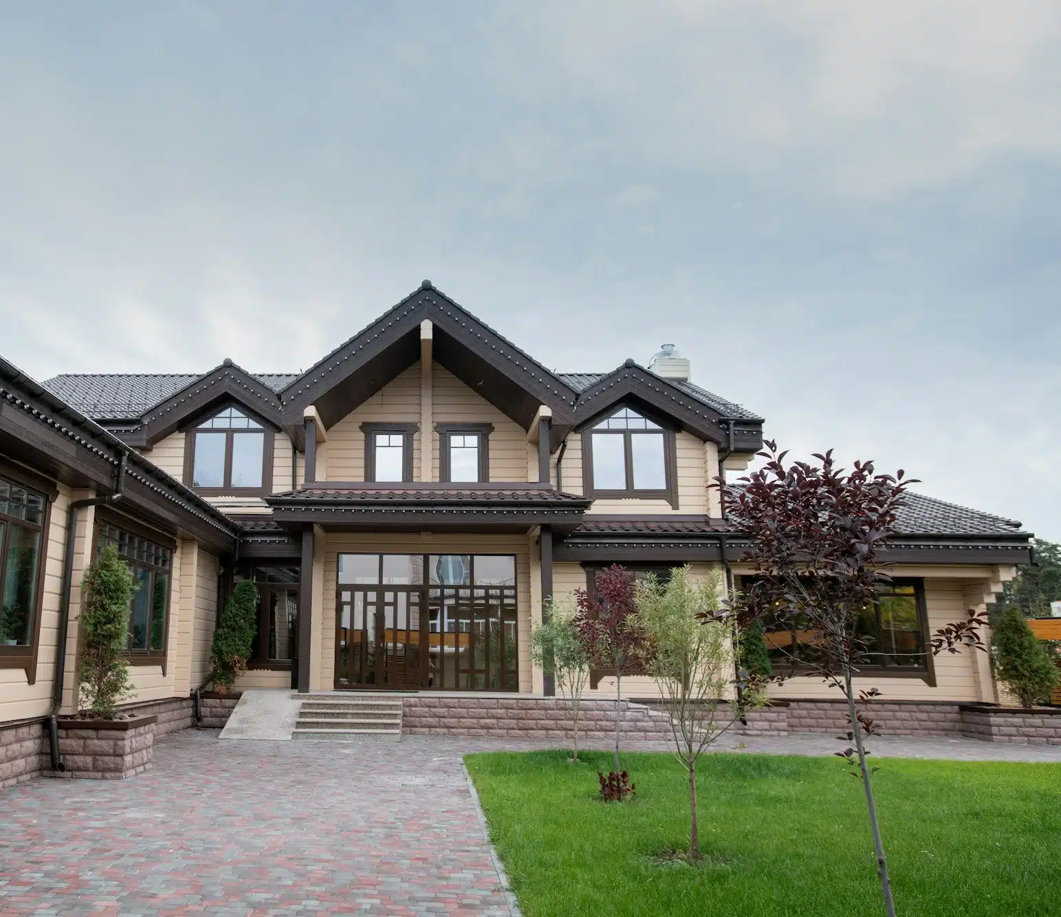 Exterior of modern comfortable cottage or house with front yard
