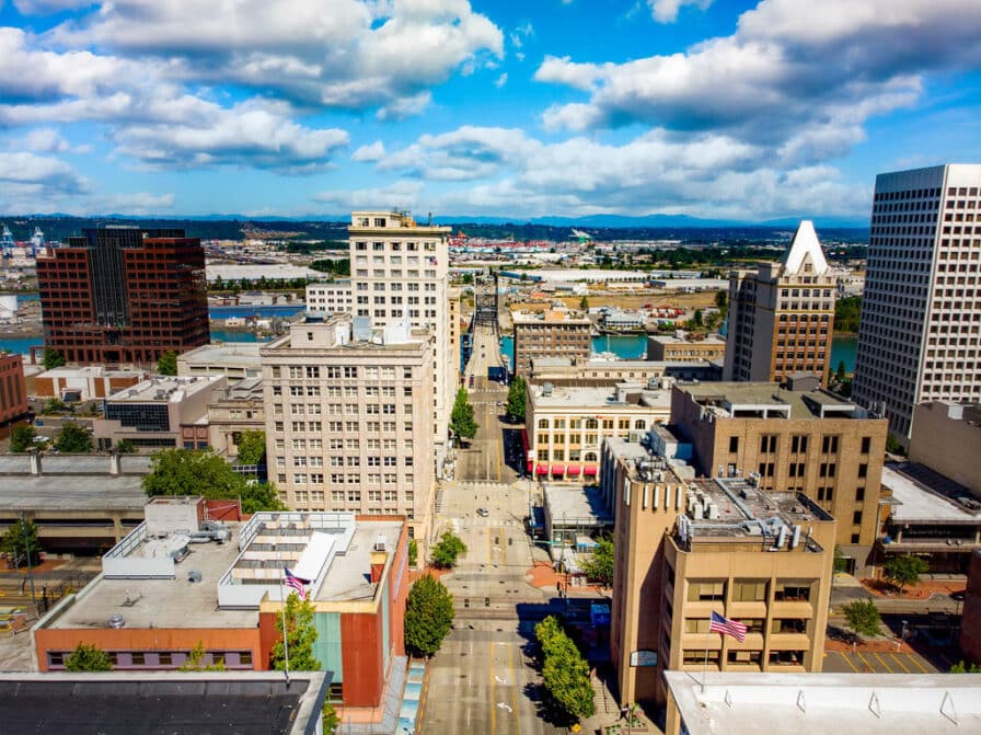 Downtown city view with tall buildings under a partly cloudy sky.