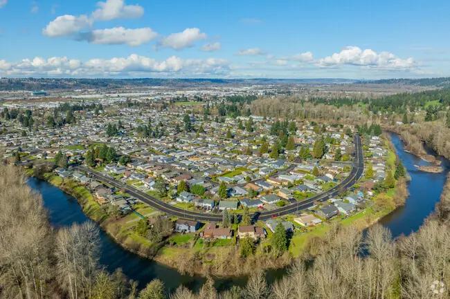 Auburn WA residential area by a river with trees and open fields.