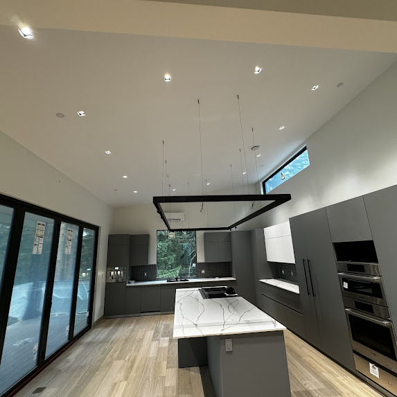 Modern luxury kitchen remodel with large island and custom cabinets by YSG Construct