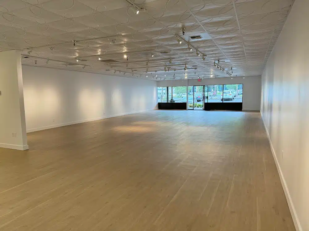 Commercial showroom renovation with new flooring, lighting, and paint by YSG Construct
