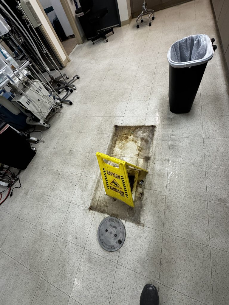 Concrete floor cutout for plumbing pipe installation during commercial remodel