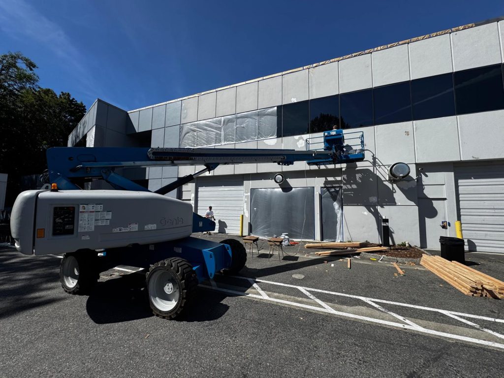 Commercial exterior painting using boom lift for large building in Bellevue Washington