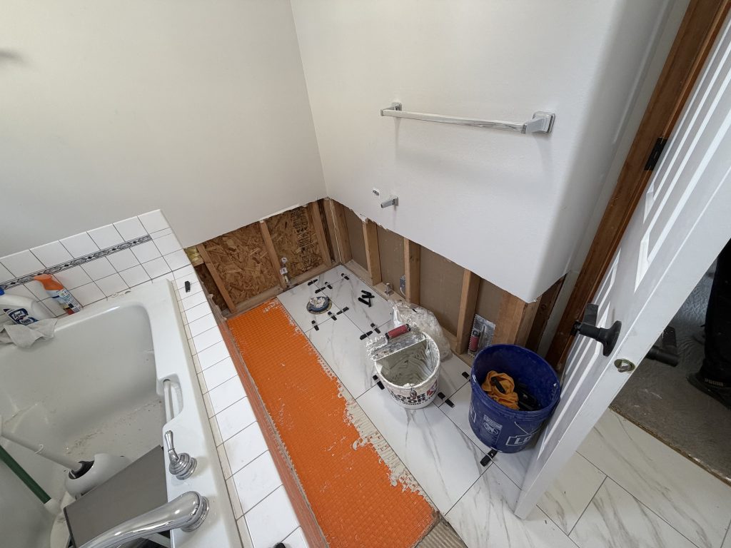 Bathroom wall opened during water damage demolition