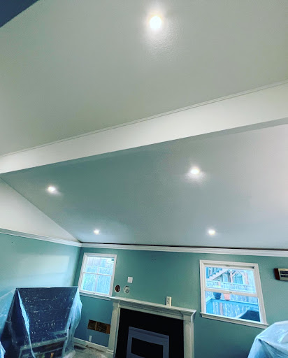 Smooth finished ceiling with glowing recessed LED can lights after popcorn removal by YSG Construct