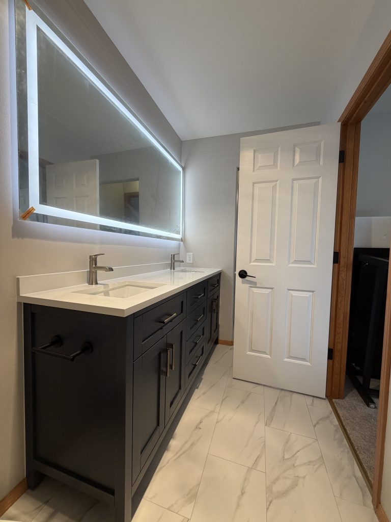 Finished bathroom with double vanity and LED mirror