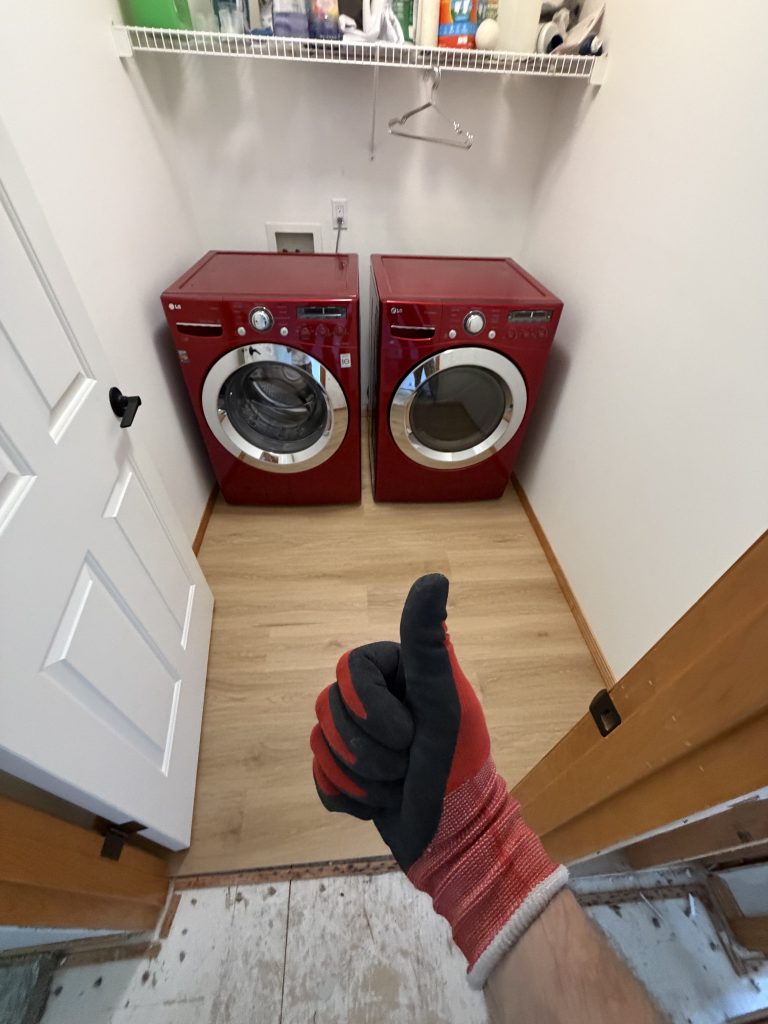Completed laundry room restoration with new flooring