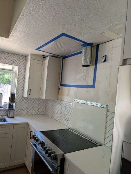 Containment plastic sealed over a kitchen ceiling during mold cleanup in Bothell