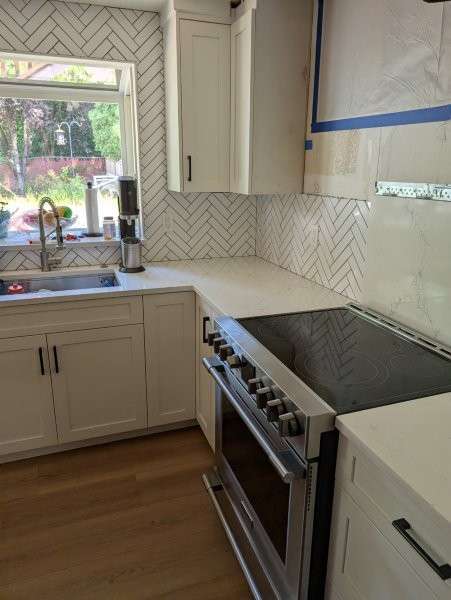 Bothell kitchen mid-restoration — upper cabinets removed and work area cleaned
