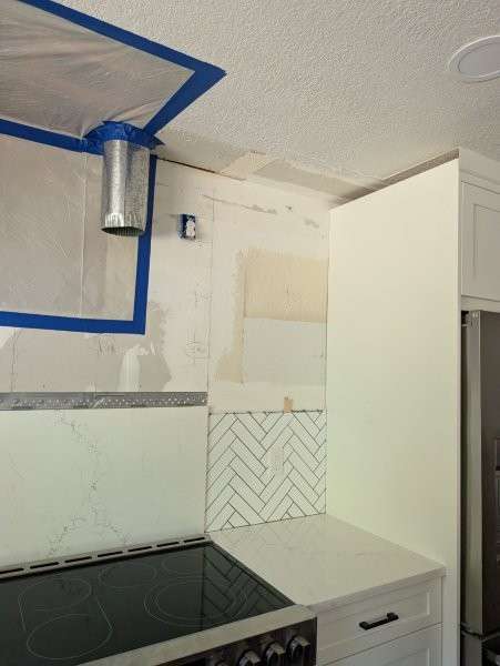 Ceiling opening sealed with containment plastic and duct during Bothell mold cleanup