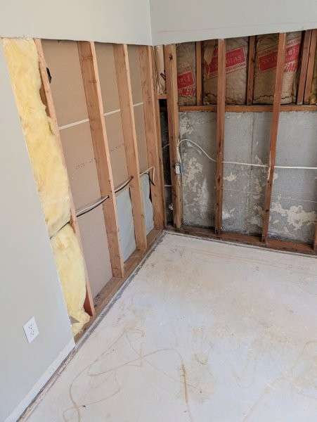 Opened basement walls stripped to the framing — water damage restoration in Brier, WA by YSG Construct