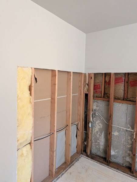 Opened basement walls in a wide view after moisture and mold cleanup — water damage restoration in Brier, WA by YSG Construct