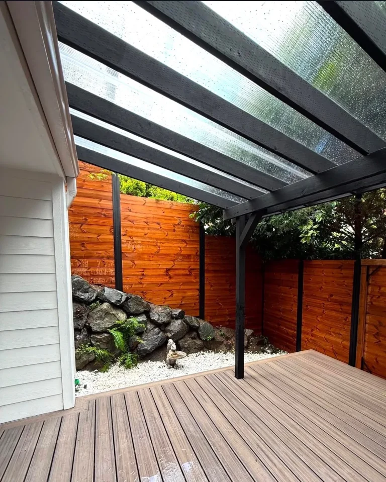 Composite deck under a glass pergola cover, built by YSG Construct in the Bellevue area