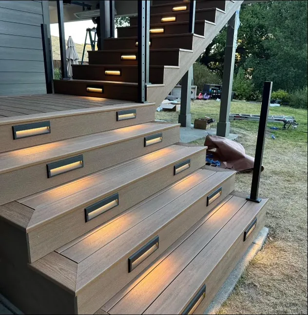 Composite deck stairs with built-in LED step lighting at dusk, built by YSG Construct, deck contractor in Bellevue & the Eastside