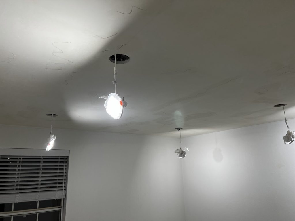 Temporary work lights hanging during recessed lighting installation
