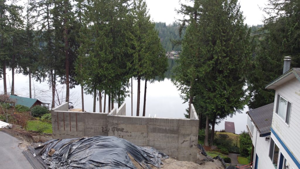 Concrete foundation walls overlooking the lake — custom home foundation by YSG Construct, Ames Lake WA