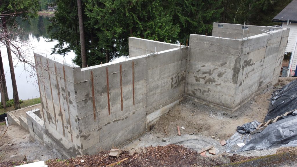Tall reinforced concrete foundation walls at lakeside — YSG Construct foundation contractor, Ames Lake WA