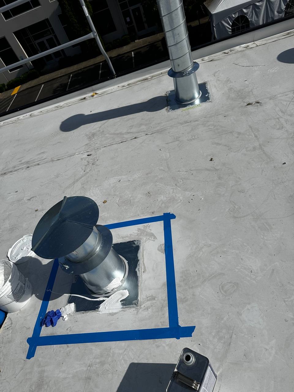 Sealing a roof vent penetration with masking tape on a commercial roof in Lacey WA