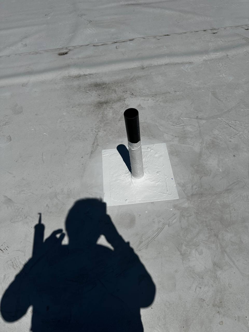 Small sealed roof vent pipe on flat commercial roof in Lacey WA