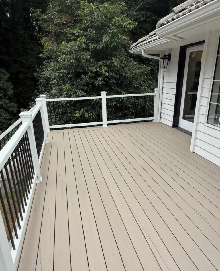 Light composite deck with white railing and black balusters, YSG Construct decking project