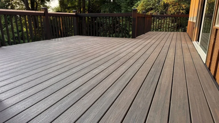Open composite deck surface with dark railing, built by YSG Construct
