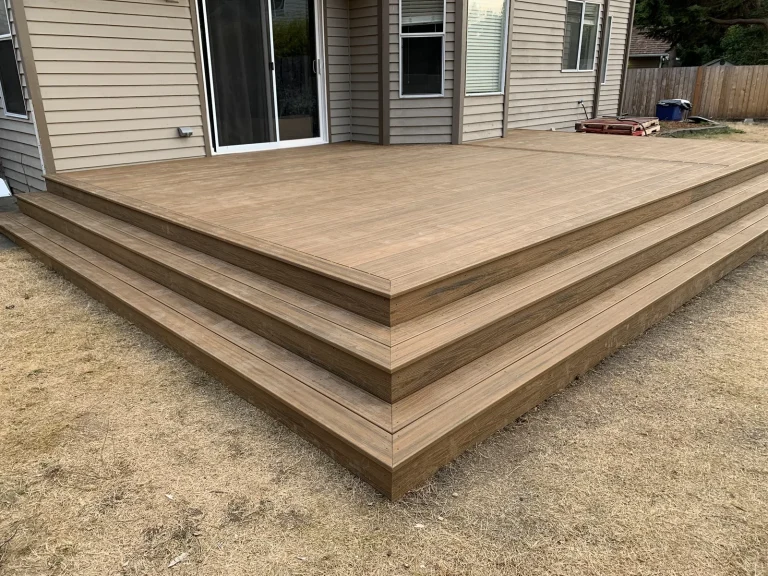 Low platform composite deck with wide wrap-around steps, built by YSG Construct