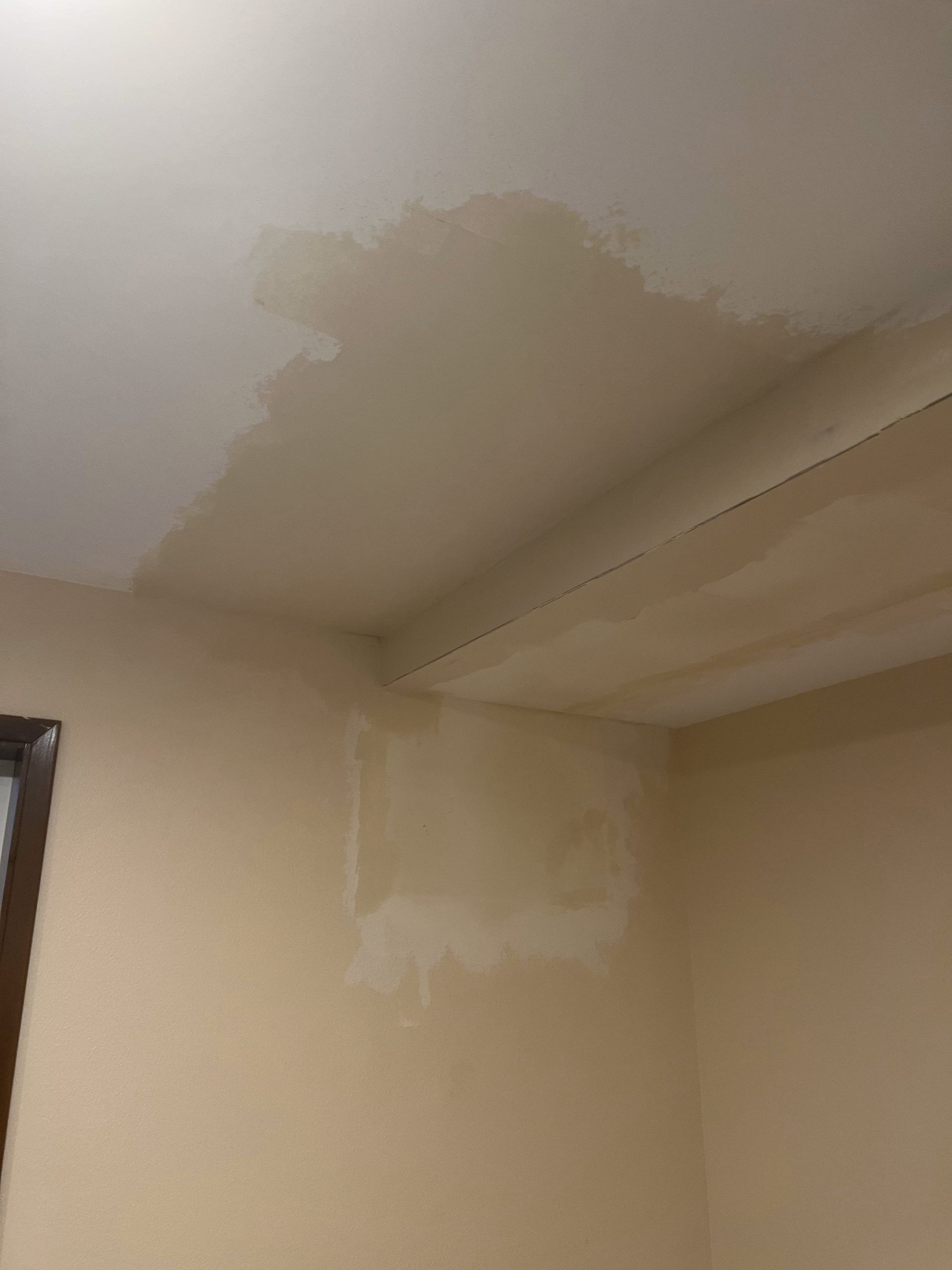 Interior water damage stains on ceiling and wall repaired by YSG Construct in Redmond WA