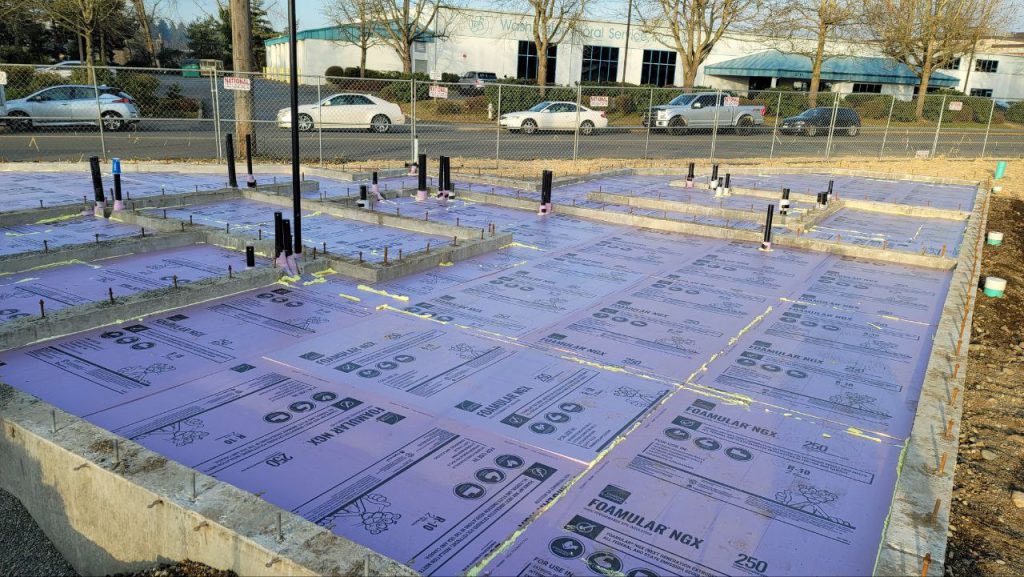 Slab area covered with taped foam board insulation in Tacoma WA by YSG Construct