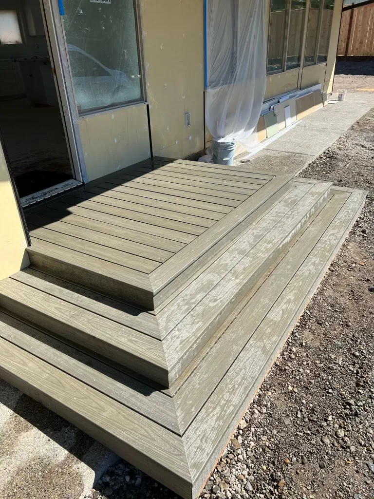 Compact platform deck with steps at a home entrance, built by YSG Construct