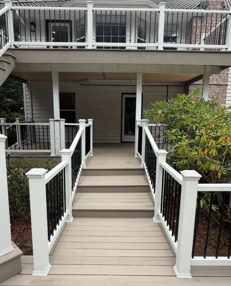 Two-level composite deck with white railings and black balusters, built by YSG Construct in the Bellevue area