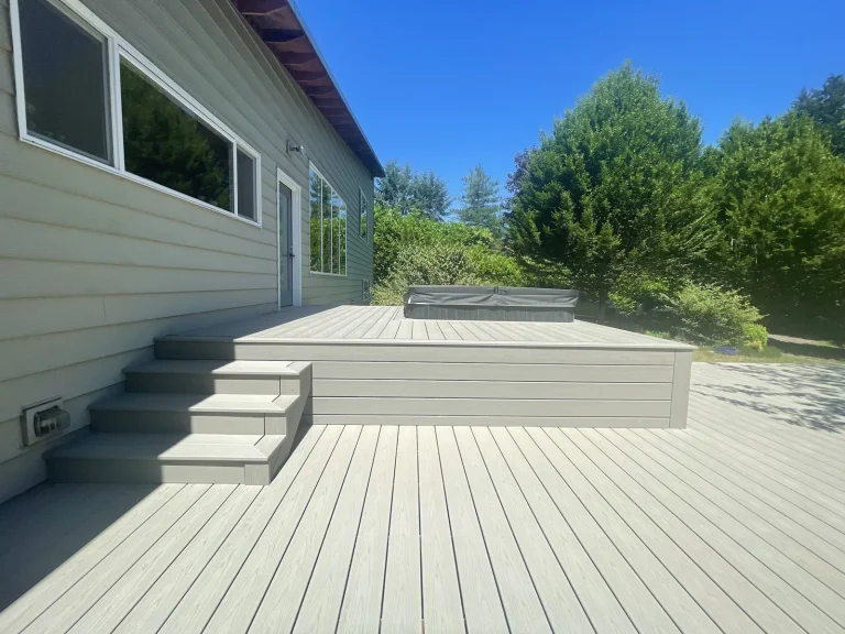 Light gray two-level composite deck on a sunny day, YSG Construct deck project in the Bellevue area